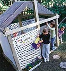 Playhouse made with plastic lattice and a canvas roof